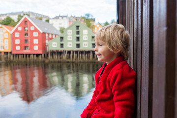 Wall Mural - Cute child, boy, visiting Trondheim, Norway during the summer, enjoying city architecture