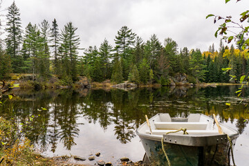 Wall Mural - rowing boat on a lake on a fall day in Mont Tremblant National Park, in Laurentides region of Quebec, Canada