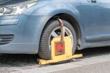 Fototapeta Miasto - Wheel clamp. Penalty for parking car on restricted place.