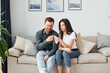 © standret - Couple sitting together on the sofa in domestic room
