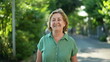 © Marco - Happy senior woman walking forward smiling in city nature