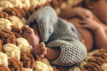Cute Shot Of Baby Feet. Fluffy Blanket Underneath And Wool Clothes. Family Moments. Baby's First Photoshoot. High Quality Photo