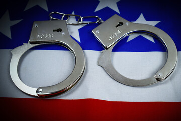 handcuffs on the background of the USA flag, the concept of crime in the United States of America