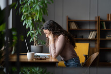 Young Frustrated Female Employee Getting Stuck On Task Or Project, Sitting In Front Of Laptop Holding Head In Hands And Thinking, Tired Account Manager Cant Deal With Deadline At Work. Selective Focus