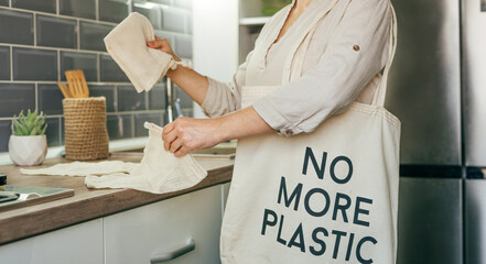 Wall Mural - Young woman taking reusable cotton bags for shopping