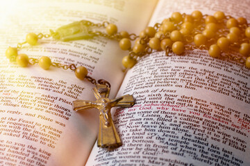Wall Mural - Traditional Catholic rosary on open Bible