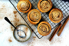 Freshly Baked Traditional Sweet Cinnamon Rolls On A Cooling Rack
