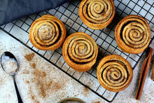 Freshly Baked Traditional Sweet Cinnamon Rolls On A Cooling Rack