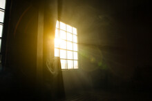 Sunshine Window Reflection On The Wooden Floor. Heavy Smoke In Loft Design Studio. Cinematic Photo.