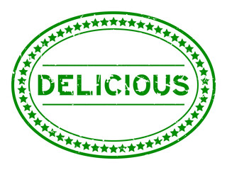 Sticker - Grunge green delicious word oval rubber seal stamp on white background