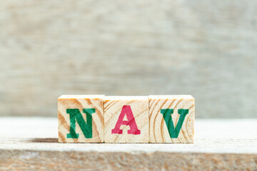 Sticker - Alphabet letter block in word NAV (Abbreviation of Net asset value) on wood background