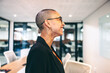© Jacob Lund - Cheerful businesswoman smiling in a modern workplace