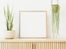Square Empty Frame Mockup In Interior With Slat Sideboard And Hanging  Green Plant In Pot On Empty Wall Background. 3D Rendering, Illustration