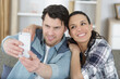 © auremar - young couple pose for selfie taken on phone