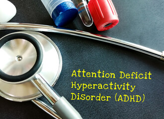 Sticker - ADHD – attention deficit hyperactivity disorder term on blackboard with medical equipment.