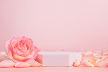 Empty Podium With Pink Rose Flowers On Pink Background To Display Products, Gift Or Cosmetics. Podium With Copy Space For Design Or Advertising
