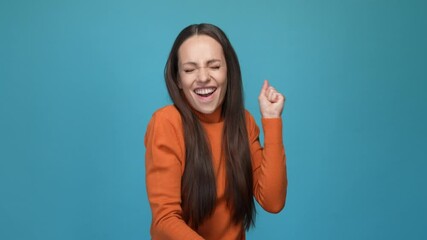 Wall Mural - Delighted lady fist up luck fortune isolated blue color background