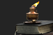 Really Old Oil Lamp On A Bible