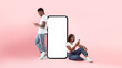 Couple showing white empty smartphone screen and texting