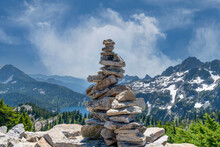 Stacked Rocks Cairn On Mountain Peak Hiking Trail.