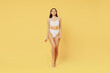 © ViDi Studio - Full size confident beautiful young sexy brunette woman 20s wearing white underwear with perfect fit figure look camera isolated on plain yellow color background studio. People female beauty concept