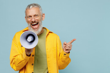 Wall Mural - Elderly happy gray-haired mustache bearded man 50s in yellow shirt hold scream in megaphone announces discounts sale Hurry up point finger aside isolated on plain pastel light blue background studio