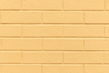 Pastel Yellow Painted Brick Wall Texture Background.