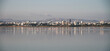 panorama with many flamingo birds in larnaka salt lake and skyline in background, cyprus