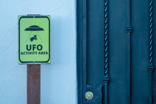 Curious "ufo Activity Area" Warning Sign Next To A House Door