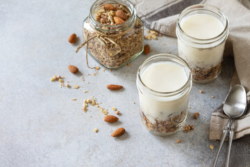 Sticker - Healthy breakfast, yogurt parfait. Yogurt with homemade almond granola on a gray concrete background. Copy space.