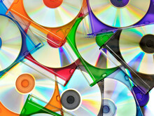 Colorful Compact Discs In Boxes Stacked In A Pile As Background
