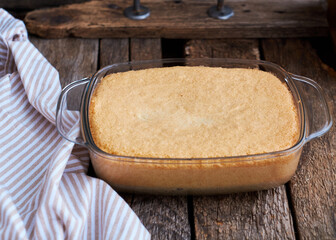 Sticker - Sponge cake in a glass rectangular plate on a wooden table.