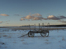 Old Wagon In Frozen Prairie At Sunrise