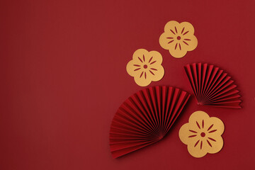 Chinese new year festival or wedding decoration over red background. Traditional lunar new year paper fans. Flat lay, top view, banner