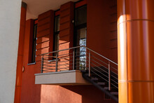 Glass Door, Brown Front Doors With A Nice Staircase With Black Hand Railing.