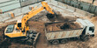 Excavator digs pit foundation. Earthwork in excavation in construction site, aerial top view.