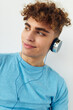 © Tatiana - Attractive man in blue t-shirts headphones fashion isolated background
