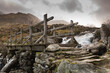 Wooden footbridge crossing a stream and waterfall in The Ogwen Valley in Snowdonia National Park, Wales.