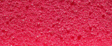 Close-up, Background, Texture, Large Long Horizontal Banner. Heterogeneous Surface Fine Pore Structure Bright Saturated Red Pumice Stone For Finger Care. Full Depth Of Field. High Resolution Photo