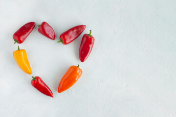 Wall Mural - Colorful sweet peppers in a heart shape, top view, copy space