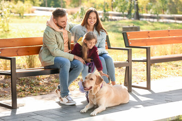 Sticker - Happy family with Labrador dog sitting on bench in park