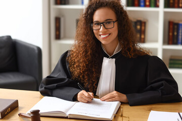 Wall Mural - Female judge sitting at workplace in courtroom