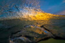 Ocean Wave Detail With Sunset Light Illuminating The Water