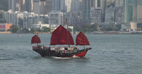 Fototapete - Red sail junk cross over Hong Kong city