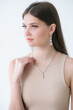 Trending silver jewelry set on a beautiful young girl with long dark hair. Beauty and fashion 