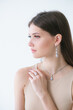 Trending silver jewelry set on a beautiful young girl with long dark hair. Beauty and fashion 