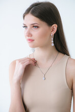Trending Silver Jewelry Set On A Beautiful Young Girl With Long Dark Hair. Beauty And Fashion 