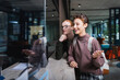 © LIGHTFIELD STUDIOS - Young woman with backpack talking near boyfriend and hotel reception