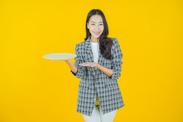 Wall Mural - Portrait beautiful young asian woman smile with empty plate dish