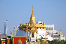 Stunning View Of Phu Khao Thong (Golden Mount) Of Wat Saket Temple With The Spires Of Loha Prasat (Iron Castle) Of Wat Ratchanatdaram Temple In Foreground, Bangkok City Skyline, Thailand